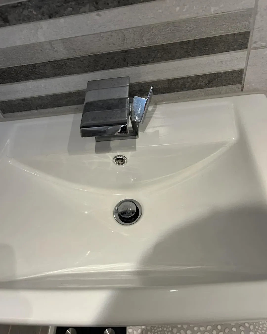 Finished bathroom basin and tap installation
