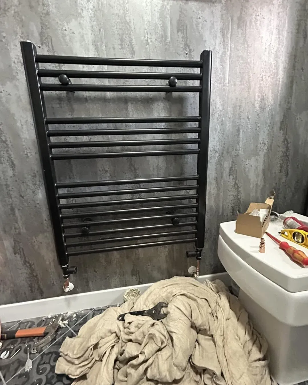 Black heated towel radiator installation