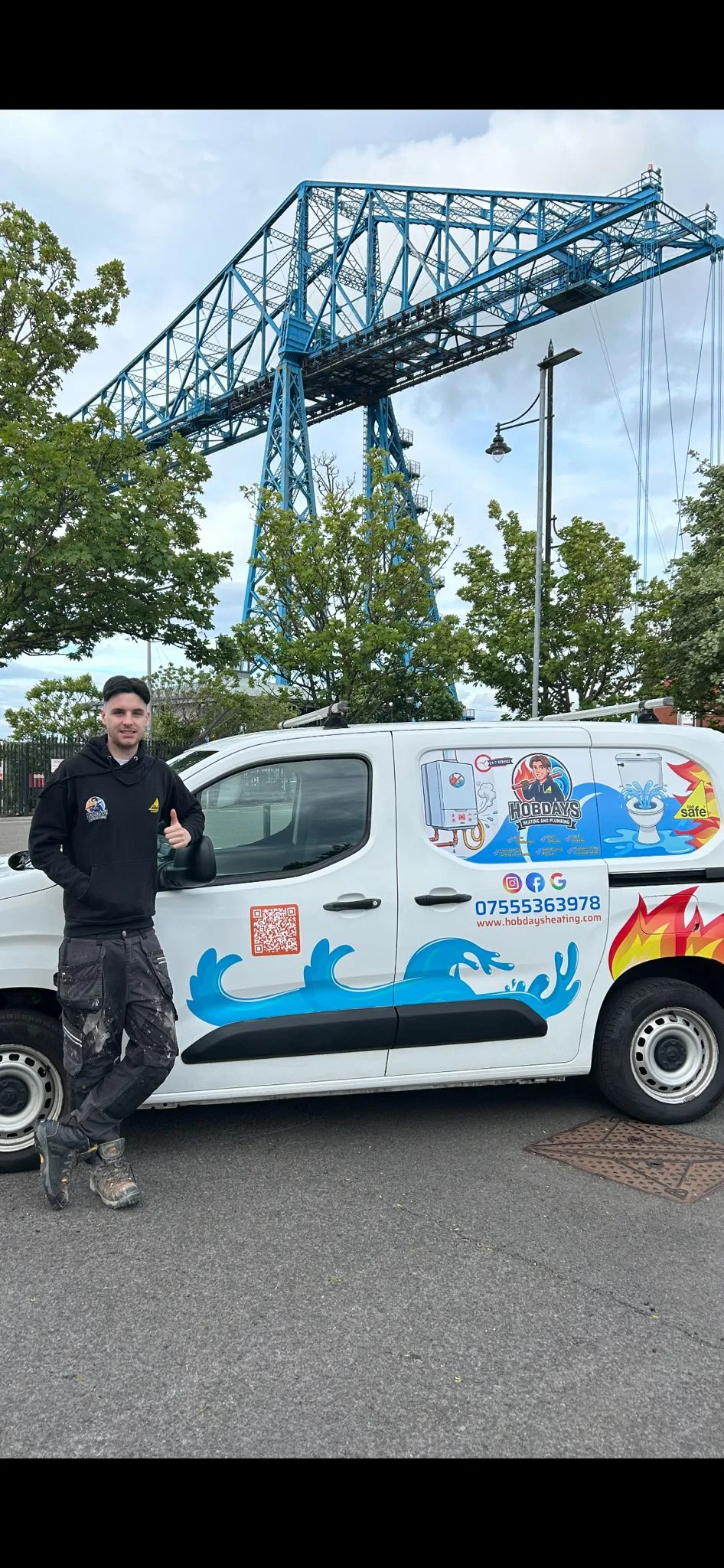 Zak from Hobday's Heating & Plumbing with his branded van by the Middlesbrough Transporter Bridge